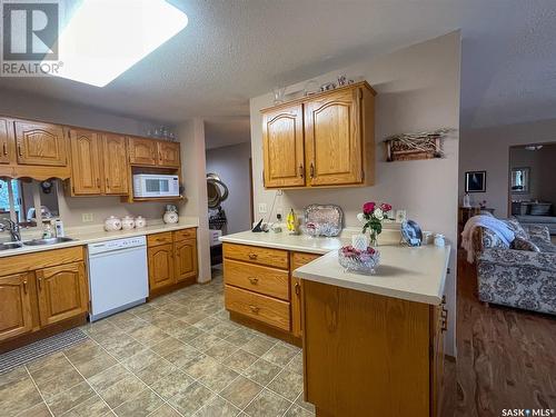 301 119 4Th Avenue W, Kindersley, SK - Indoor Photo Showing Kitchen With Double Sink