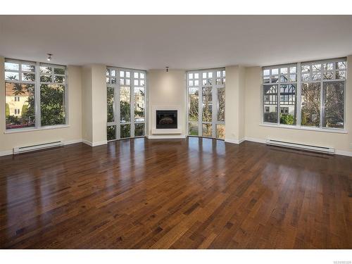 306-999 Burdett Ave, Victoria, BC - Indoor Photo Showing Living Room With Fireplace