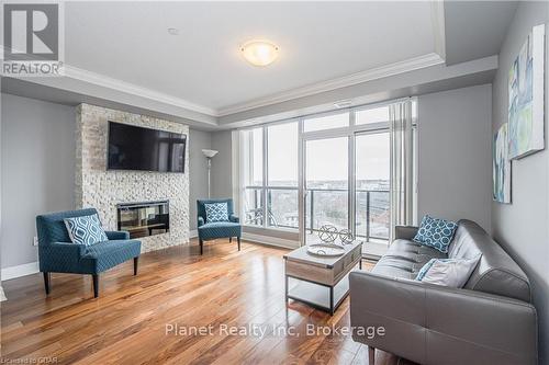 901 - 150 Wellington Street E, Guelph (Central West), ON - Indoor Photo Showing Living Room With Fireplace