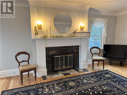 Living area featuring a high end fireplace and hardwood / wood-style flooring - 166 North Street, Fort Erie, ON - Indoor Photo Showing Living Room With Fireplace