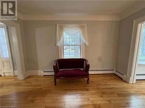 Sitting room featuring light hardwood / wood-style floors and a baseboard radiator - 166 North Street, Fort Erie, ON - Indoor Photo Showing Other Room