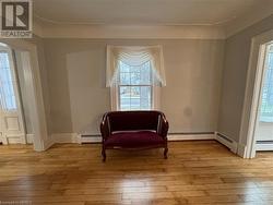 Sitting room featuring light hardwood / wood-style floors and a baseboard radiator - 