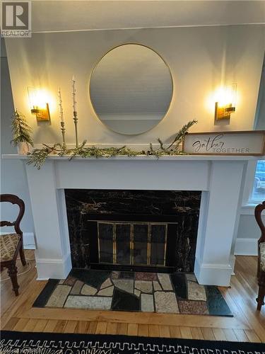 Interior details featuring hardwood / wood-style flooring and a premium fireplace - 166 North Street, Fort Erie, ON - Indoor Photo Showing Other Room With Fireplace