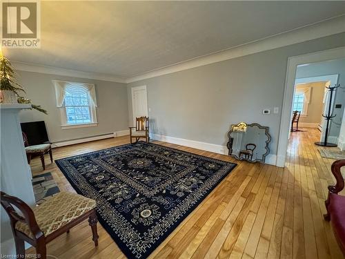 Living area featuring hardwood / wood-style flooring, crown molding, and a baseboard heating unit - 166 North Street, Fort Erie, ON - Indoor Photo Showing Other Room