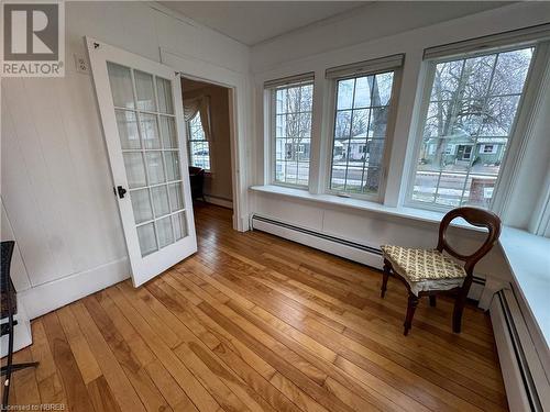 Unfurnished room featuring plenty of natural light, a baseboard heating unit, and light wood-type flooring - 166 North Street, Fort Erie, ON - Indoor