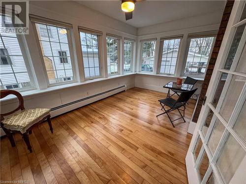 Sunroom with ceiling fan, a wealth of natural light, and a baseboard heating unit - 166 North Street, Fort Erie, ON - Indoor Photo Showing Other Room