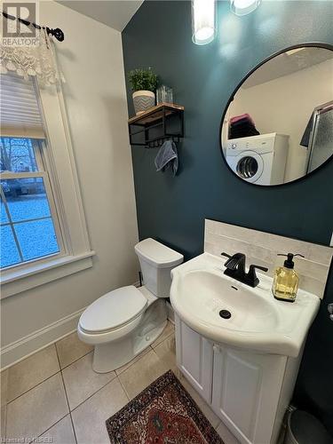 Bathroom with washer / dryer, tile patterned flooring, vanity, and toilet - 166 North Street, Fort Erie, ON - Indoor Photo Showing Bathroom