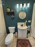 Bathroom with tile patterned flooring, vanity, and toilet - 