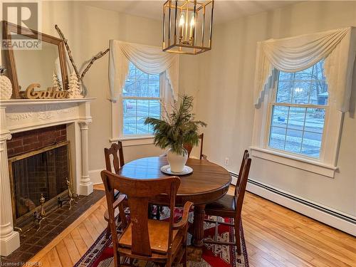 Dining space with baseboard heating and hardwood / wood-style floors - 166 North Street, Fort Erie, ON - Indoor Photo Showing Dining Room With Fireplace