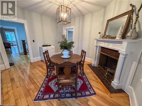 Dining room with a notable chandelier and light hardwood / wood-style flooring - 166 North Street, Fort Erie, ON - Indoor Photo Showing Dining Room With Fireplace