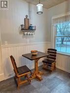 Dining space with wooden ceiling and dark wood-type flooring - 