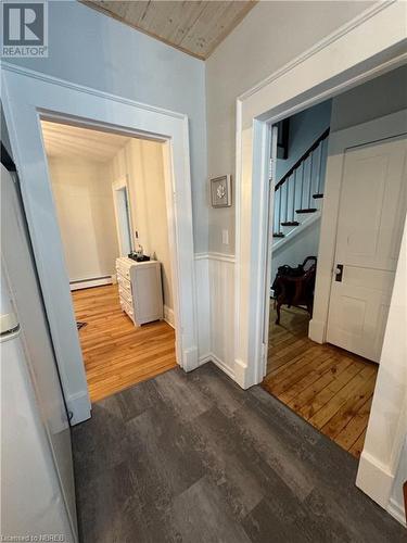 Hall with dark hardwood / wood-style flooring, wooden ceiling, and a baseboard heating unit - 166 North Street, Fort Erie, ON - Indoor Photo Showing Other Room