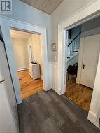 Hall with dark hardwood / wood-style flooring, wooden ceiling, and a baseboard heating unit - 