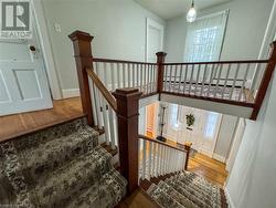 Staircase featuring hardwood / wood-style floors - 