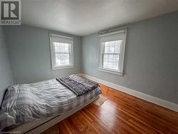 Bedroom with hardwood / wood-style flooring - 