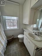 Bathroom featuring tile patterned flooring, vanity, and toilet - 