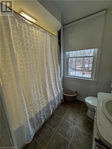 Bathroom featuring tile patterned flooring, a shower with curtain, and toilet - 166 North Street, Fort Erie, ON - Indoor Photo Showing Bathroom