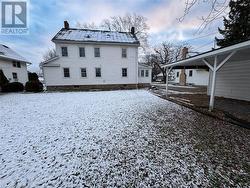 Snow covered property with a carport - 