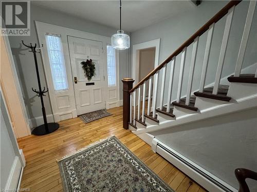 Foyer entrance featuring light hardwood / wood-style flooring and a baseboard radiator - 166 North Street, Fort Erie, ON - Indoor Photo Showing Other Room