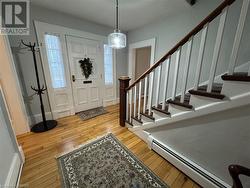 Foyer entrance featuring light hardwood / wood-style flooring and a baseboard radiator - 