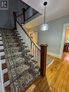 Staircase featuring hardwood / wood-style floors - 