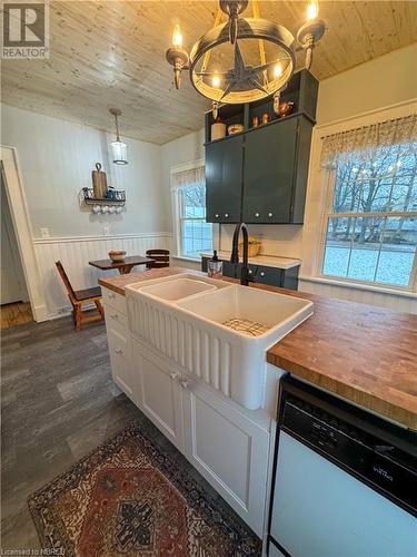 Kitchen featuring dishwasher, an inviting chandelier, sink, decorative light fixtures, and dark hardwood / wood-style flooring - 166 North Street, Fort Erie, ON - Indoor