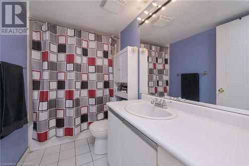 Bathroom with tile patterned floors, vanity, and toilet - 305 Webb Drive Unit# 308, Mississauga, ON 