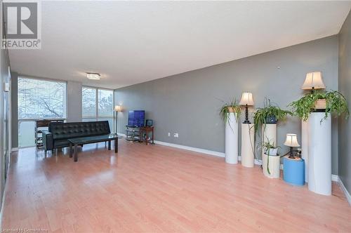 Sitting room with light hardwood / wood-style floors and a textured ceiling - 305 Webb Drive Unit# 308, Mississauga, ON 