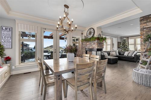 1169 Bellagio Avenue, Kelowna, BC - Indoor Photo Showing Dining Room With Fireplace