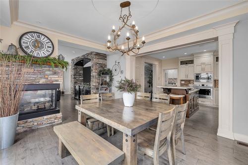 1169 Bellagio Avenue, Kelowna, BC - Indoor Photo Showing Dining Room With Fireplace