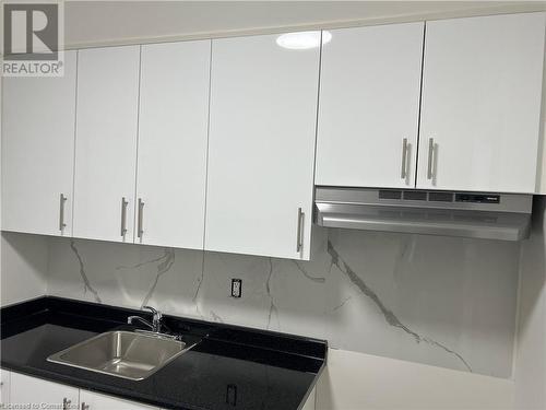 Kitchen featuring white cabinetry - 660 Main Street E Unit# 2, Hamilton, ON - Indoor Photo Showing Kitchen With Double Sink