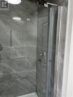 Bathroom featuring a shower with shower door - 