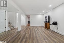 Basement with dark wood-type flooring - 