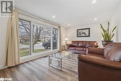 Living room with wood-type flooring - 