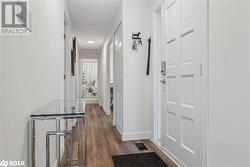 Corridor with dark hardwood / wood-style flooring - 