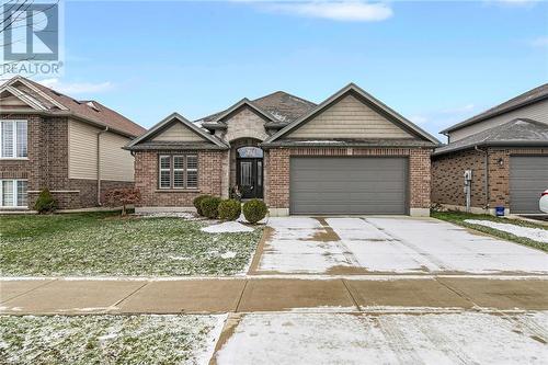 View of front of home featuring a front yard and a garage - 46 Halliday Drive Drive, Tavistock, ON - Outdoor With Facade