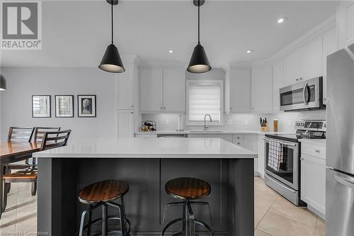 Kitchen featuring white cabinetry, sink, a kitchen island, and stainless steel appliances - 46 Halliday Drive Drive, Tavistock, ON - Indoor Photo Showing Kitchen With Upgraded Kitchen