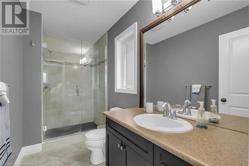 Bathroom featuring tile patterned flooring, vanity, toilet, and a shower with door - 46 Halliday Drive Drive, Tavistock, ON - Indoor Photo Showing Bathroom