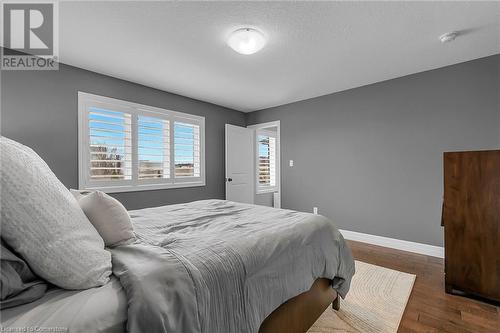 Bedroom featuring dark hardwood / wood-style flooring and a textured ceiling - 46 Halliday Drive Drive, Tavistock, ON - Indoor Photo Showing Bedroom