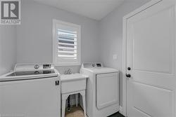 Washroom featuring washing machine and clothes dryer - 