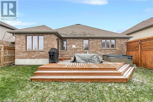 Rear view of property with a lawn, a hot tub, and a deck - 46 Halliday Drive Drive, Tavistock, ON - Outdoor With Deck Patio Veranda With Exterior