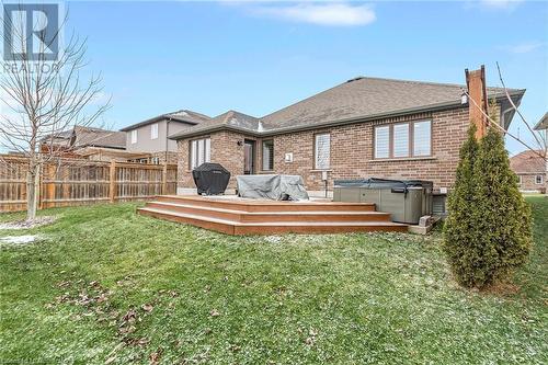 Back of property featuring a yard, a deck, and a hot tub - 46 Halliday Drive Drive, Tavistock, ON - Outdoor With Deck Patio Veranda