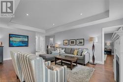 Living room with hardwood / wood-style flooring and a tray ceiling - 