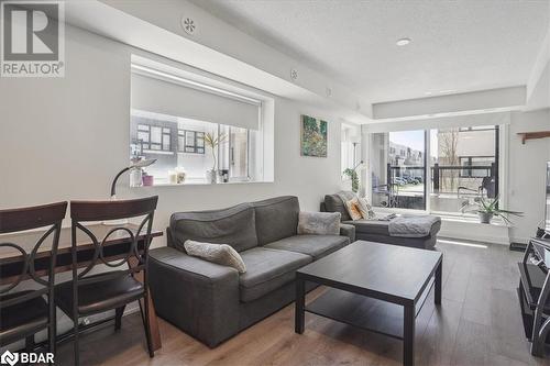 Living room featuring hardwood / wood-style floors and a textured ceiling - 1141 Cooke Boulevard Unit# 416, Burlington, ON - Indoor Photo Showing Living Room