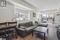 Living room featuring hardwood / wood-style floors and a textured ceiling - 