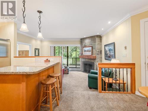 2 4510 Blackcomb Way, Whistler, BC - Indoor Photo Showing Kitchen With Fireplace