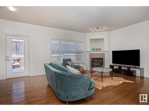 #127 89 Rue Monette, Beaumont, AB - Indoor Photo Showing Living Room With Fireplace