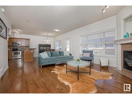 #127 89 Rue Monette, Beaumont, AB - Indoor Photo Showing Living Room With Fireplace