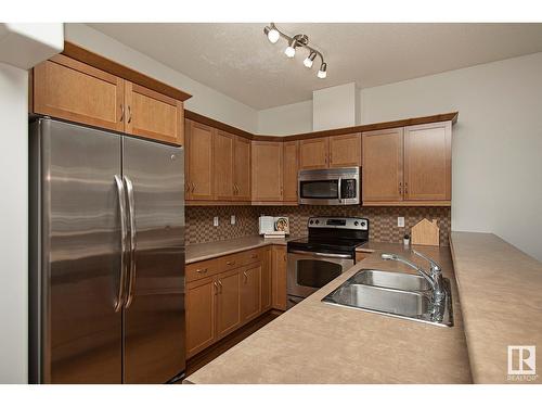 #127 89 Rue Monette, Beaumont, AB - Indoor Photo Showing Kitchen With Double Sink