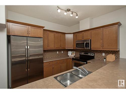 #127 89 Rue Monette, Beaumont, AB - Indoor Photo Showing Kitchen With Double Sink